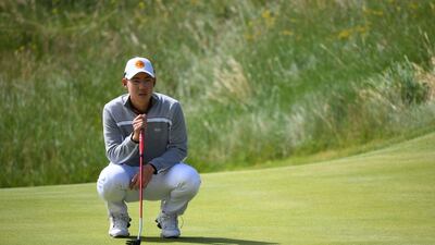 Thailand's Jazz Janewattananond putts on the 16th during his second round on day 2 of The 149th British Open Golf Championship at Royal St George's, Sandwich in south-east England on July 16, 2021. (Photo by ANDY BUCHANAN / AFP) / RESTRICTED TO EDITORIAL USE