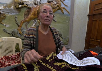 Iraqi Christian Karjiya Baqtar embroiders a precious prayer shawl using golden thread, to gift to Pope Francis. AFP