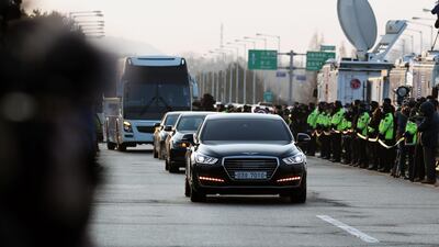 Vehicles carrying South Korean delegates pass a military check point on the Unification Bridge, linked to North Korea, near the demilitarised zone at dawn in Paju, South Korea, on Tuesday. SeongJoon Cho / Bloomberg