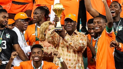President of Ivory Coast Alassane Ouattara lifts the Africa Cup of Nations trophy. AFP