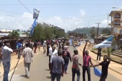 A still from a video shot on October 1, 2017 shows protesters waving Ambazonian flags in Cameroon's Bamenda city. via Reuters TV