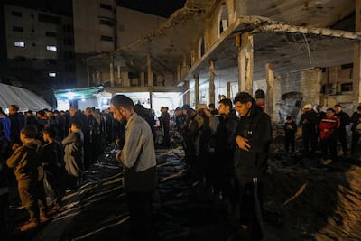 Palestinians attend taraweeh prayers at Al Kinz mosque in Gaza city on the first night of Ramadan, as communities try to preserve traditions amid destruction and displacement. EPA