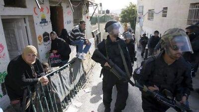 Israeli riot police file past Palestinian homes in the Ras al Amud neighborhood of East Jerusalem. Ahmad Gharabli / AFP