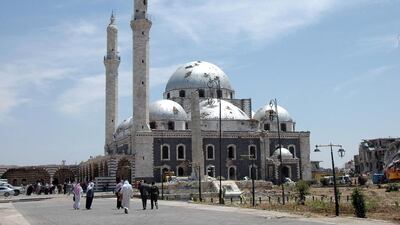 Syrians head to the Khaled bin Al Waleed mosque in the Al Khalidiyah neighbourhood for the first Friday prayers to be held there since fighting started in Syria’s central city three years ago. In July 2013, Syrian army shelling destroyed the centuries-old mausoleum of the mosque, according to reports of a monitoring group and activists. AFP Photo