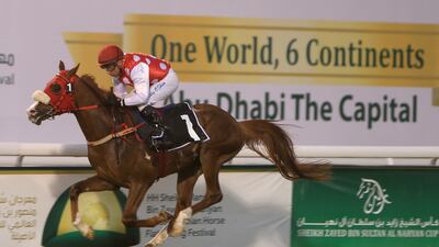 Tadhg O'Shea rides Rb Torch to the win in the Hamdan Handicap on Monday night at Abu Dhabi Equestrian Club. Ravindranath K / The National