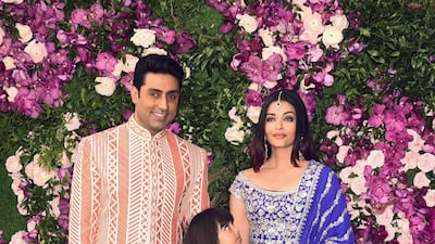 Bollywood actor Abhishek Bachchan (L) poses for photographs along with his wife and actress and model Aishwarya Rai Bachchan (R), and their daughter (C), as they arrive to attend the wedding ceremony of Akash Ambani. Photo: AFP
