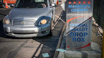 Sealed ballots are seen on the ground as a citizen drives up to drop their vote at the Maricopa County Tabulation and Election Centre on the US midterm Election Day in downtown Phoenix, Arizona. AFP