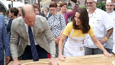 Prince William, Duke of Cambridge and Catherine, Duchess of Cambridge attempt to make pretzels during a tour of a traditional German market in the Central Square on day 2 of their official visit to Germany. Chris Jackson / Getty Images