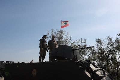 Lebanese army members stand on a military vehicle during a Lebanese army media tour to review the army's operations in southern Lebanon. Reuters