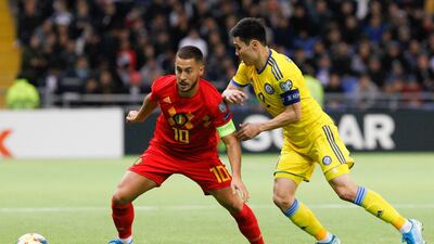 Belgium's Eden Hazard, left, and Kazakhstan's Bauyrzhan Islamkhan go for the ball during the Euro 2020 qualifying match at the Astana Arena Stadium. AP