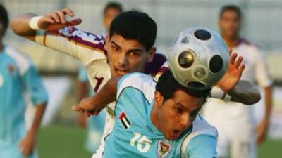 Ahmad Qadir, left, loses an aerial battle against Al Ain.