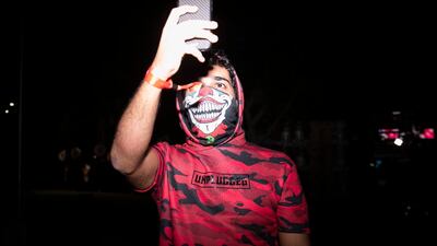 A fan takes a picture at RedFestDXB 2020. Reem Mohammed/The National