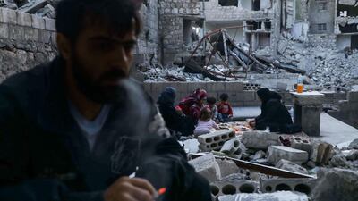 Tariq Abu Ziad smoking as members of his family break their fast together. AFP
