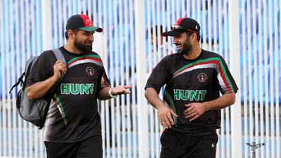 Afghanistan coach Kabir Khan, left, walking with Nawroz Mangal during a practice session at Sharjah Cricket Stadium in Sharjah on March 1, 2014. Pawan Singh / The National