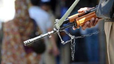 An Indian police officer stands guard to maintain peace between Muslims and Hindus.