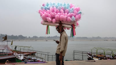 A candy floss seller waits for customers beside the Ganges in Varanasi, northern India. AFP
