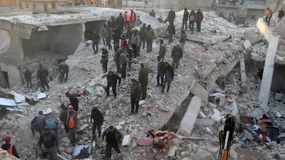 Civil defence workers and civilians search the rubble of a collapsed building in the Sheikh Maqsoud neighbourhood of Aleppo. AP