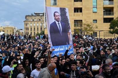Supporters of former Lebanese Prime Minister Saad Hariri shout slogans as they carry his picture during a rally on the 17th anniversary of the assassination of his father late Lebanese Prime Minister Rafic Hariri. EPA