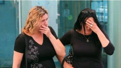 Israeli women whose relatives were among the victims of a bombing in Bulgaria wait for their arrival at the Ben Gurion airport in Tel Aviv.