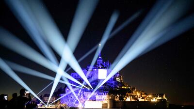 A show at the Mont Saint-Michel abbey lights up the night sky during festivities to mark the millennium of the monument. AFP