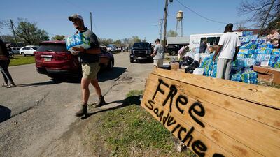 Volunteers try to help the storm-affected residents in Rolling Fork. AP