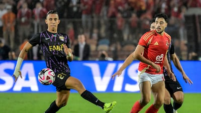 Al Ahly's Akram Tawfik battles for the ball with Al Ain's Soufiane Rahimi. AFP