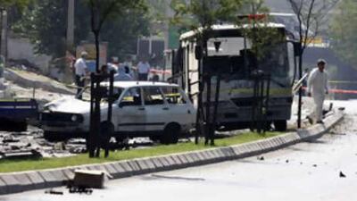 Turkish police forensic officers investigate the site after a car explosion injured at least 16 people, mostly police officers, in western Turkish city of Izmir.