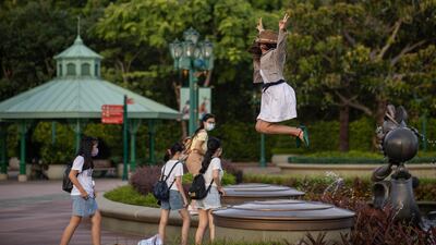 A visitor jumps for photographs in Disneyland in Hong Kong, China. The theme park will shut its doors until July 21, 2020 due to a surge in Covid-19 cases in Hong Kong. EPA