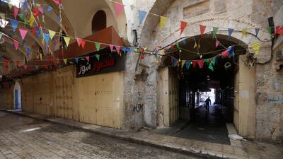 A Palestinian man walks in an empty street during a general strike in the West Bank city of Nablus, May 18. EPA