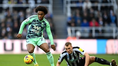 Fulham attacker Willian in possession with Dan Burn of Newcastle on the ground. Getty