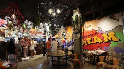 The Burgr Factory features graffiti on the walls and several fun elements such as a giant Monopoly board. Pawan Singh/The National