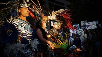 Juan Flores (left) a traditional Aztec dancer looks on during a rally in San Diego, California, in support for the protesters at Standing Rock, North Dakota who are fighting construction of the Dakota Access Pipeline. The US government last week sought to stop construction on a controversial oil pipeline in North Dakota that has angered Native Americans, blocking any work on federal land and asking the company to “voluntarily pause” work nearby. Sandy Huffaker / AFP