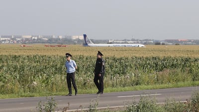 Russian police officers near the site of Ural Airlines A-321 passenger plane emergency landing outside Zhukovsky airport in Ramensky district of Moscow region, Russia. A-321 with 226 passengers and seven crew members on board en-route from Moscow to Simferopol made emergency landing after a right engine failure following the plane's colliding with seagulls shortly after take-off. Ten people were hospitalized following the accident. EPA