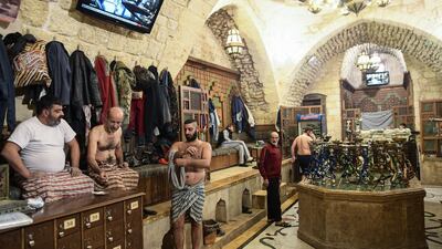 Men dry up after bathing at Hammam Al Qawwas.