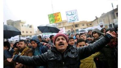 Syrians in the northern city of Idlib gather to begin demonstrating against the regime after Friday prayers yesterday.