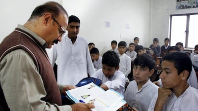 Teacher Mohammad Alam, 48, in a newly-built classroom in Ahingaro Dherai village