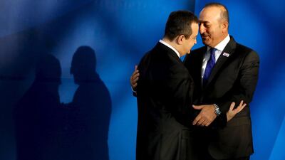 OSCE chairman Serbian foreign minister Ivica Dacic (L) greets Turkish foreign minister Mevlut Cavusoglu as he arrives for the OSCE ministerial council meeting in Belgrade. Mr Cavusoglu met with his Russian counterpart, Sergei Lavrov, on the sidelines of the talks. Jonathan Ernst/Reuters