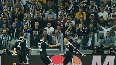 James Rodriguez of Real Madrid goes to embrace Cristiano Ronaldo after his goal to make it 1-1 against Juventus in the Champions League semi-final first leg at Juventus Stadium. Giuseppe Cacace / AFP