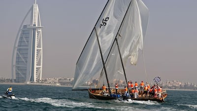 The Al-Shaqi team celebrate after crossing the finish line in the annual long-distance dhow sailing race, known as Al Gaffal, near Sir Abu Nair island. AFP