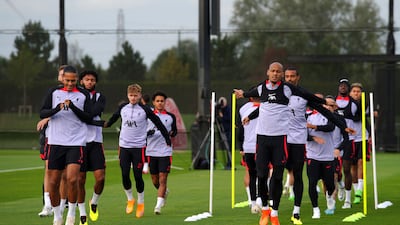 Liverpool's Virgil van Dijk, left, and Fabinho, right, training with teammates. AP