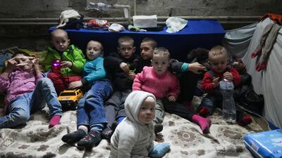 Children wait in a bomb shelter in Mariupol, Ukraine. AP