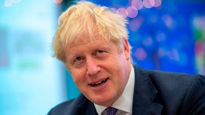 Britain's Prime Minister Boris Johnson speaks to pupils as he visits Middleton Primary School in Milton Keynes, southern England on October 25, 2019. AFP
