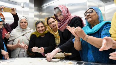 Ms May helps with food preparation during her visit to the Guru Nanak Sikh Gurdwara in Walsall to mark Vaisakhi in April 2018