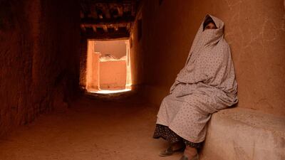 A veiled woman sits in the old part of the central eastern Moroccan city of Tinghir. Faded Senna / AFP