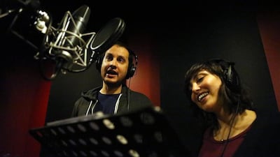 Arabic language experts are concerned that Arabic, the sixth official language of the United Nations since 1973, is at risk in Jordan and other Arab countries. Here, Ibrahim Taha and Lina Adnani are in the recording studio for Adam Wa Mishmimish. Salah Malkawi for The National