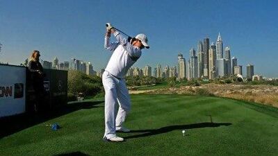 Rory McIlroy practises at the Emirates Golf Club, and is watched on by girlfriend and women’s tennis player Caroline Wozniacki.