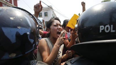 Nepalese activists of Bibeksheel Nepali party stage a protest as they march towards the prime minister's office to hand over a piece of tarpaulin to mark the one year anniversary of devastating earthquake in Kathmandu, Nepal, 24 April 2016. The youth activist chant slogan holding various placards asking the Nepalese government about the status of reconstruction and relief for the earthquake victims. Narendra Shrestha/EPA