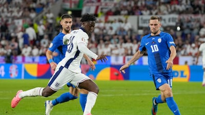 England's Kobbie Mainoo makes a break. AP