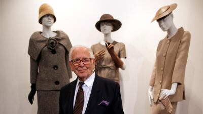Pierre Cardin poses in front of his designs from 1954, 1956 and 1957, at his fashion museum in Paris in November 2014. Reuters