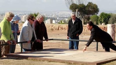 Tourists listen to a guide at the archaeological site of Carthage, near Tunis. In addition to the ruins of the ancient city, Tunisia boasts Kairouan, which is considered one of Islam's holiest cities.